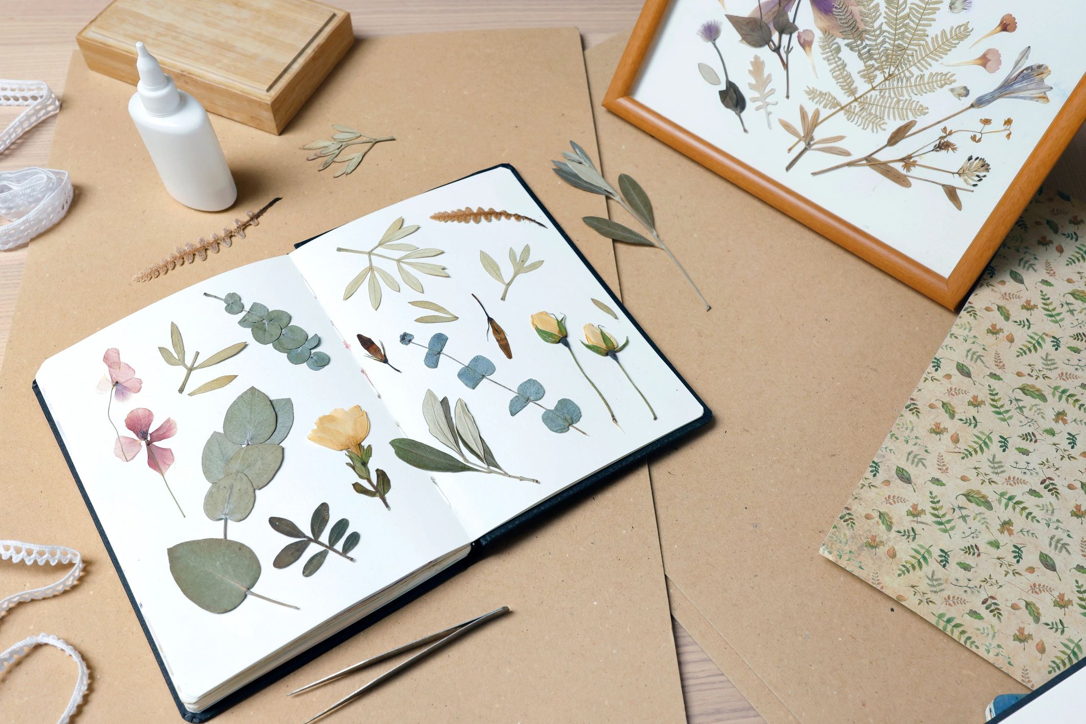 Creative workspace with botanical materials and stationery